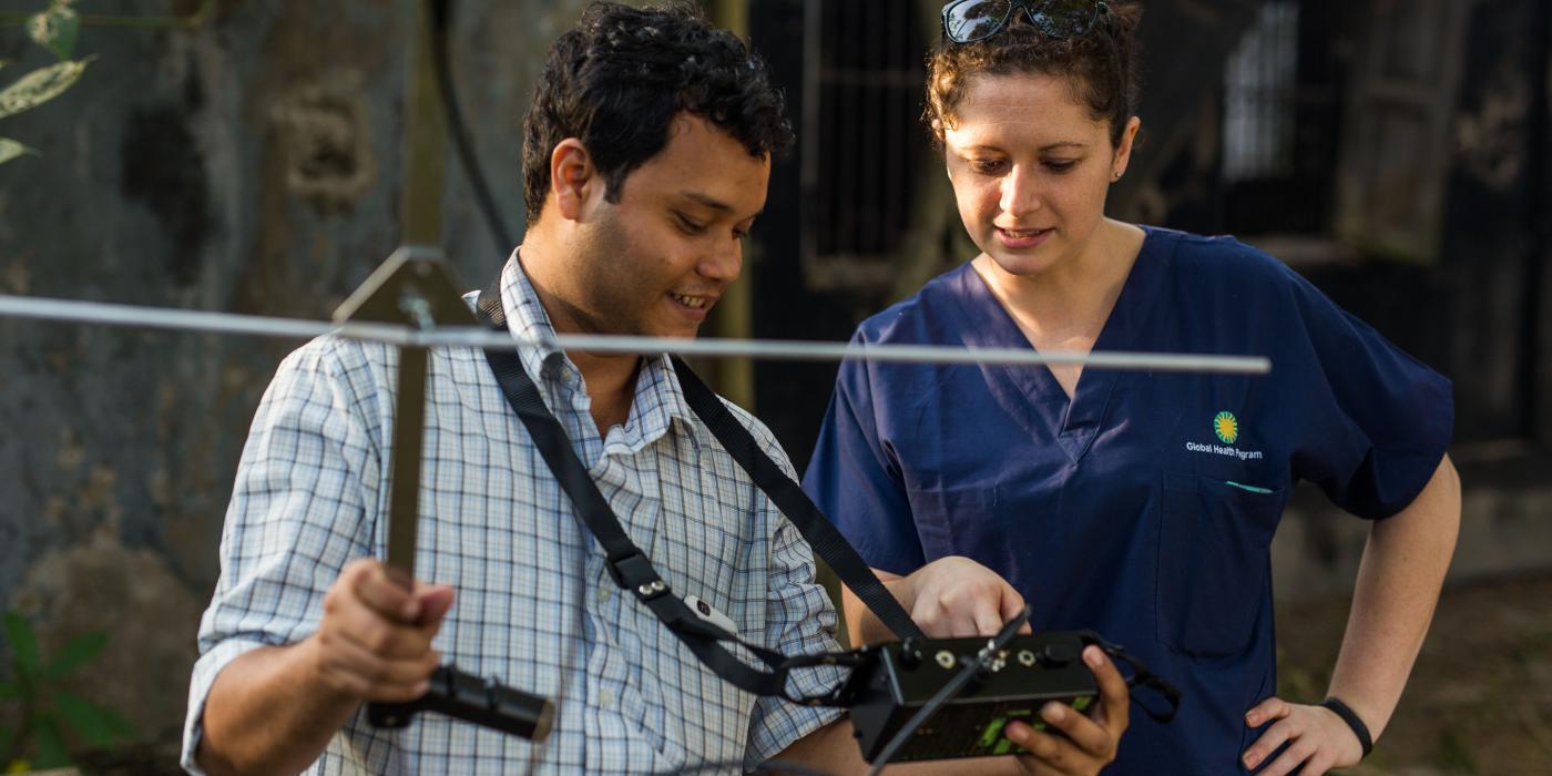 SCBI scientist Jennifer Kishbaugh (right) tests the signal on the bat collars.