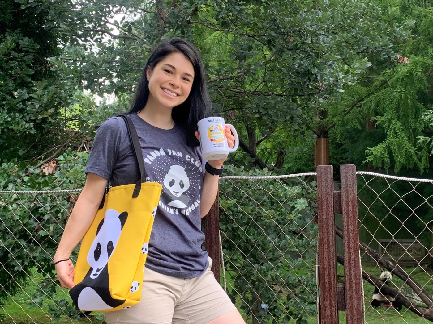 Giant panda keeper Mariel Lally models products featured in Xiao Qi Ji's first birthday merch drop.