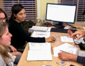 students sitting at a table having a discussion